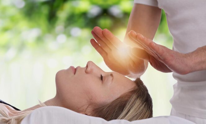 Image of a person receiving a therapeutic massage with candles in the background. Boost your mind-body connection with therapeutic massage.