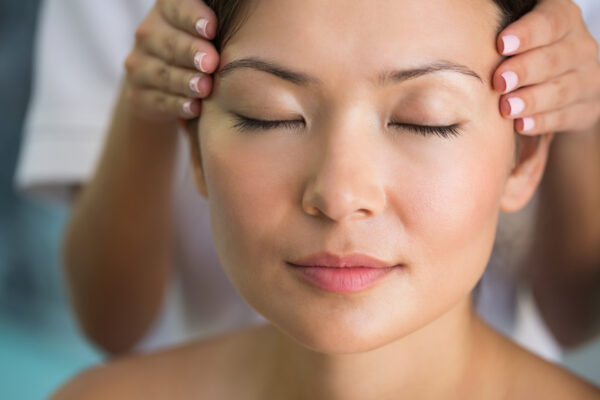 Therapist performing a targeted massage technique for migraine relief at Remedial Studio