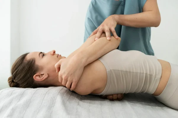 Therapist providing pain relief massage for chronic pain at Remedial Studio
